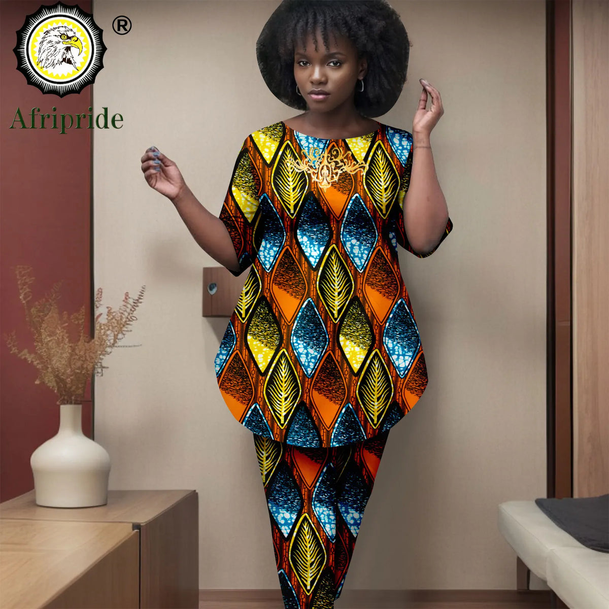 Woman wearing a colorful patterned outfit with 'Afripride' logo in the corner.