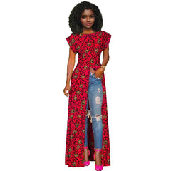 Woman wearing a red patterned dress with denim jeans